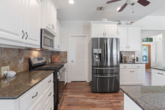 30112 Twin Creek Dr, Georgetown, TX 78626 - kitchen with appliances with stainless steel finishes, backsplash, ceiling fan, dark wood-style floors, and white cabinets