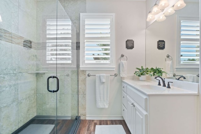 30112 Twin Creek Dr, Georgetown, TX 78626 - full bath with vanity, wood finished floors, a shower stall, and a chandelier