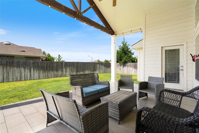136 W Highfield St, Hutto, TX 78634 - fenced backyard featuring a patio area, outdoor lounge area, and ceiling fan