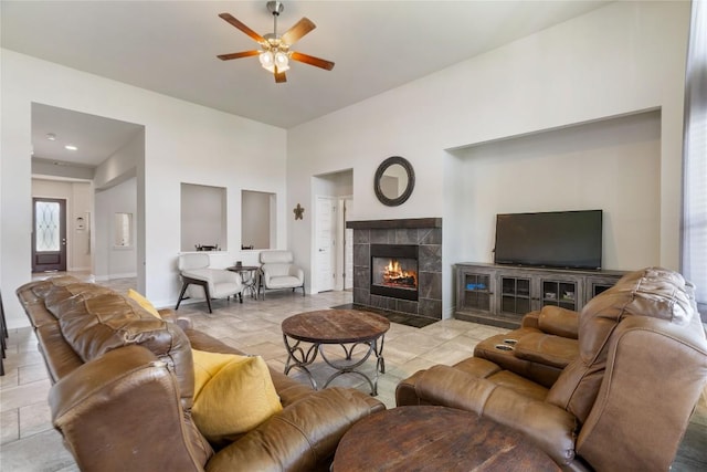 136 W Highfield St, Hutto, TX 78634 - living room featuring ceiling fan and a tiled fireplace