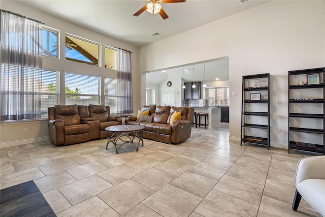 136 W Highfield St, Hutto, TX 78634 - living area featuring a ceiling fan, a towering ceiling, and light tile patterned floors