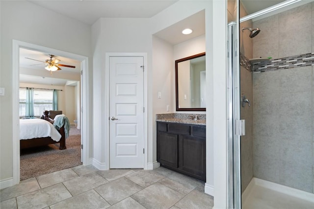136 W Highfield St, Hutto, TX 78634 - ensuite bathroom featuring a shower stall, vanity, ceiling fan, and tile patterned flooring