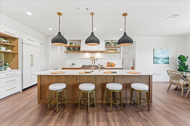 202 Hub Dr, Wimberley, TX 78676 - kitchen with open shelves, light countertops, dark wood-style floors, an island with sink, and recessed lighting