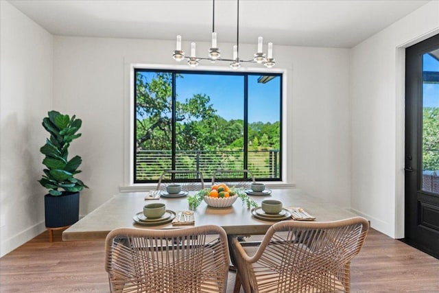 202 Hub Dr, Wimberley, TX 78676 - dining space with a chandelier and wood finished floors
