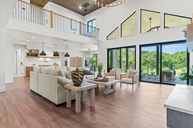 202 Hub Dr, Wimberley, TX 78676 - living area featuring a towering ceiling, wood finished floors, recessed lighting, a chandelier, and wood ceiling