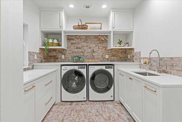 202 Hub Dr, Wimberley, TX 78676 - laundry room with washing machine and clothes dryer, cabinet space, and recessed lighting