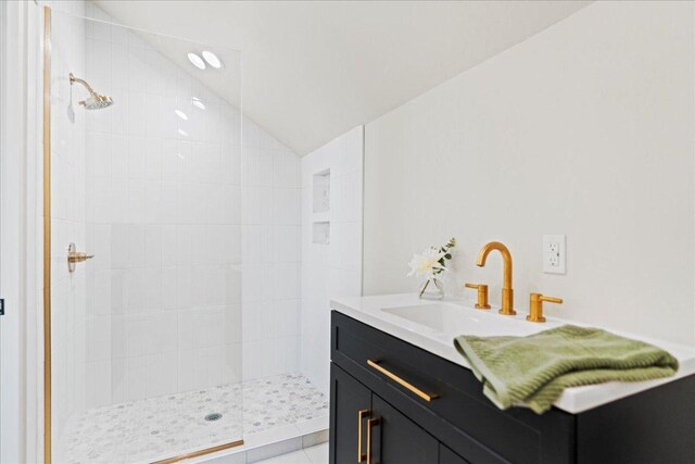 202 Hub Dr, Wimberley, TX 78676 - full bath with vaulted ceiling, a tile shower, and vanity