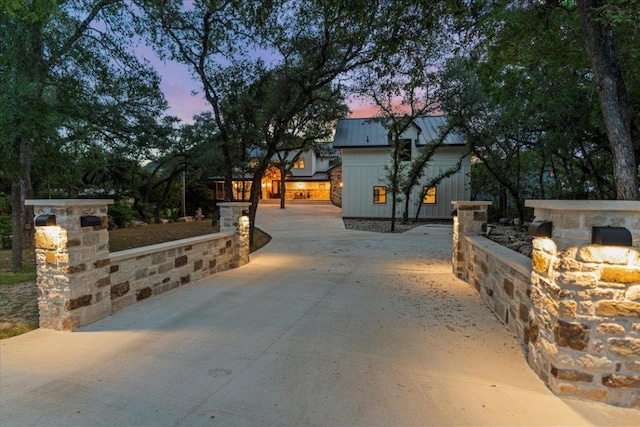 202 Hub Dr, Wimberley, TX 78676 - view of front of property with board and batten siding, a metal roof, and concrete driveway
