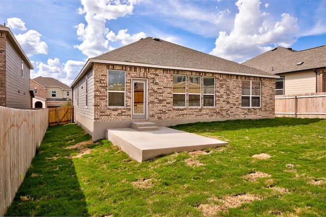 7517 Ballydawn Dr, Austin, TX 78744 - rear view of property with a fenced backyard, brick siding, and a patio area