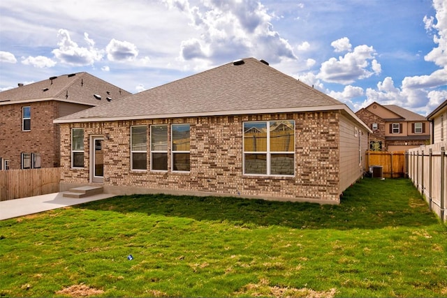 7517 Ballydawn Dr, Austin, TX 78744 - rear view of property with a fenced backyard, a shingled roof, a patio area, and brick siding
