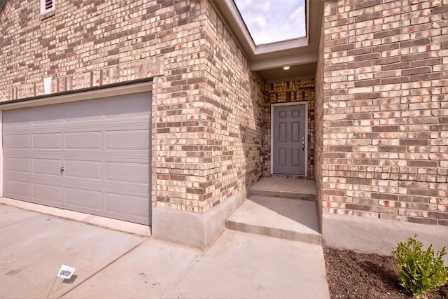 7517 Ballydawn Dr, Austin, TX 78744 - entrance to property with brick siding, a garage, and driveway