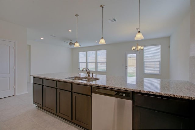 7517 Ballydawn Dr, Austin, TX 78744 - kitchen featuring stainless steel dishwasher, light stone counters, a chandelier, hanging light fixtures, and recessed lighting