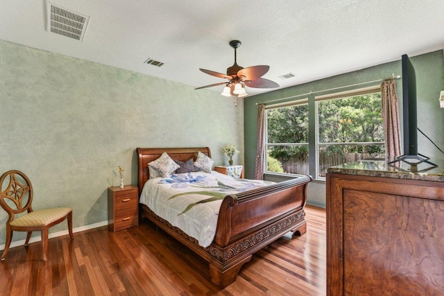 4005 Travis Country Cir, Austin, TX 78735 - bedroom featuring wood-type flooring, ceiling fan, and a textured wall
