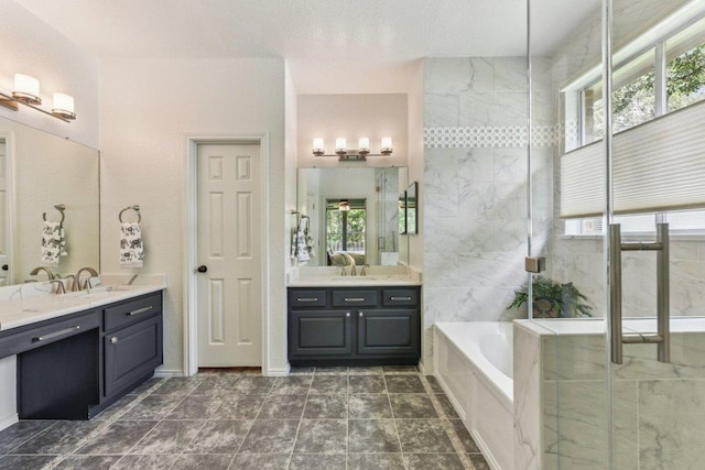 4005 Travis Country Cir, Austin, TX 78735 - bathroom featuring a bath, two vanities, a stall shower, and plenty of natural light