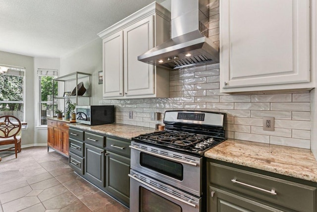 4005 Travis Country Cir, Austin, TX 78735 - kitchen with wall chimney exhaust hood, stainless steel appliances, white cabinetry, backsplash, and dark tile patterned floors