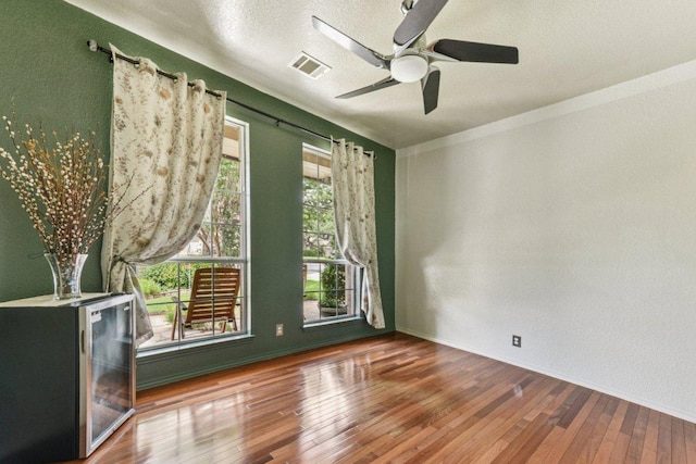 4005 Travis Country Cir, Austin, TX 78735 - unfurnished room with wood-type flooring, ceiling fan, and a textured ceiling