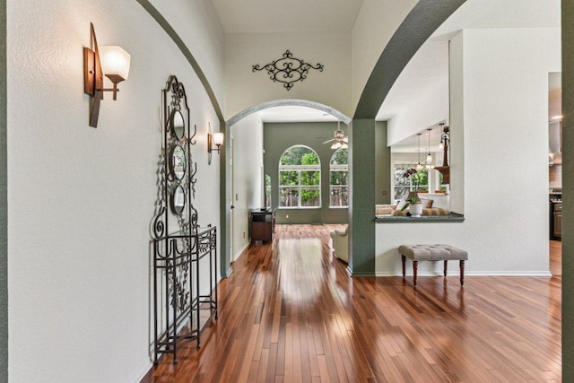 4005 Travis Country Cir, Austin, TX 78735 - foyer entrance with arched walkways, ceiling fan, and wood-type flooring