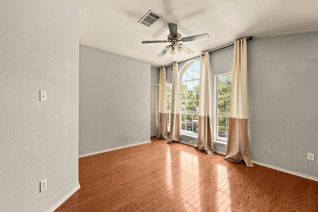 4460 Bremner Dr, Austin, TX 78749 - unfurnished room with ceiling fan, wood finished floors, and a textured wall