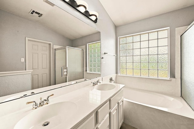 4460 Bremner Dr, Austin, TX 78749 - full bathroom featuring lofted ceiling, a garden tub, plenty of natural light, double vanity, and a stall shower