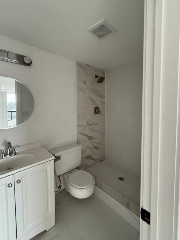 5916 Lago Vista Way Unit B16, Leander, TX 78645 - bathroom with a shower stall, vanity, and marble look tiles