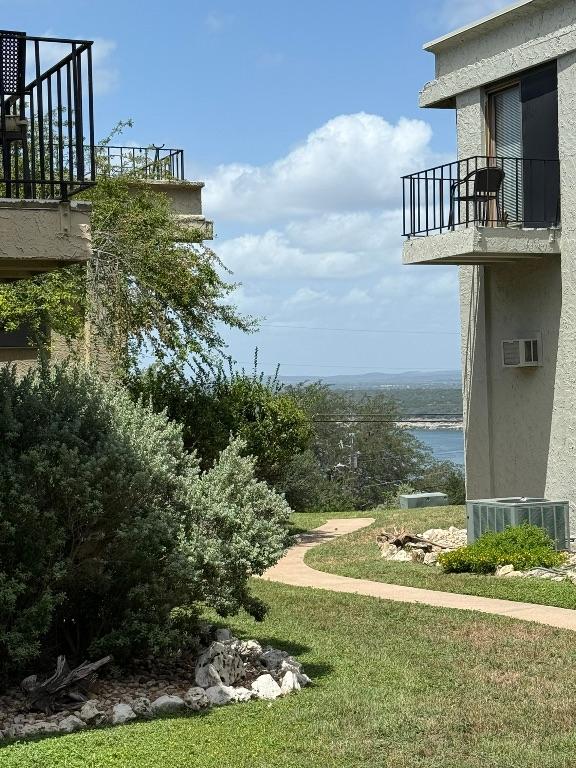 5916 Lago Vista Way Unit B16, Leander, TX 78645 - view of yard featuring a balcony and a wall mounted air conditioner
