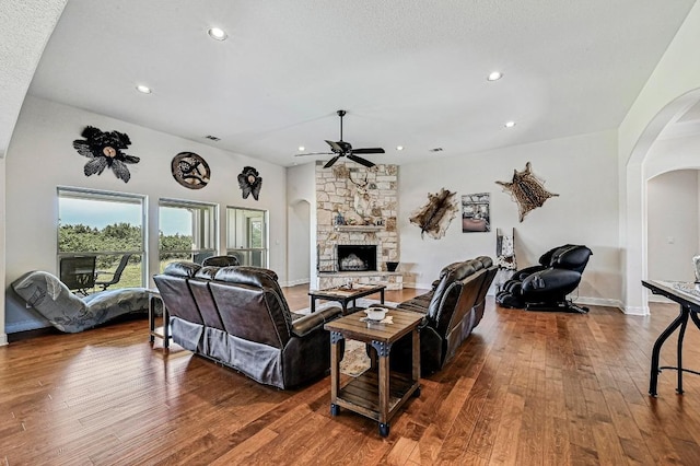 312 First Down Dash, Bertram, TX 78611 - living room featuring arched walkways, a stone fireplace, ceiling fan, wood-type flooring, and recessed lighting