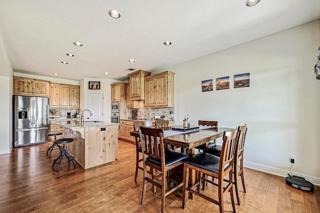312 First Down Dash, Bertram, TX 78611 - dining area with light wood-style floors and recessed lighting