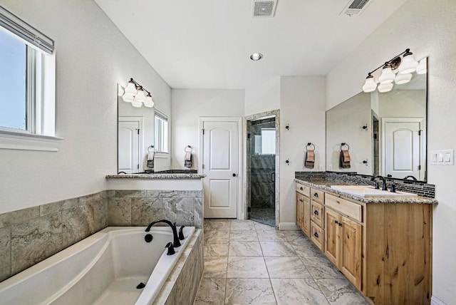 312 First Down Dash, Bertram, TX 78611 - bathroom with a bath, a stall shower, vanity, and marble finish flooring