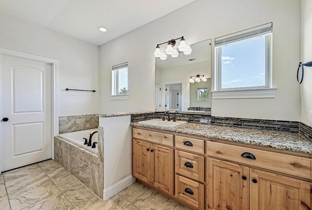 312 First Down Dash, Bertram, TX 78611 - bathroom with marble look tile flooring, a bath, and vanity