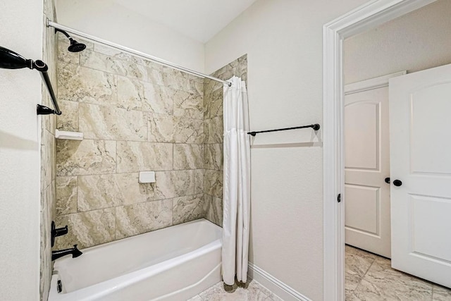 312 First Down Dash, Bertram, TX 78611 - full bathroom featuring shower / bath combo with shower curtain and baseboards