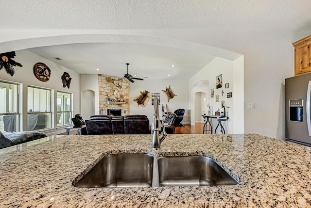 312 First Down Dash, Bertram, TX 78611 - kitchen with open floor plan, a ceiling fan, stainless steel refrigerator with ice dispenser, arched walkways, and recessed lighting
