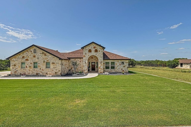 312 First Down Dash, Bertram, TX 78611 - french country style house featuring stone siding and a front yard