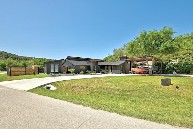 12501 Mixson Dr, Austin, TX 78732 - view of front of house featuring driveway, a carport, and board and batten siding