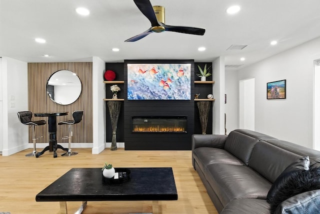 12501 Mixson Dr, Austin, TX 78732 - living area featuring recessed lighting, wood finished floors, a glass covered fireplace, and a ceiling fan