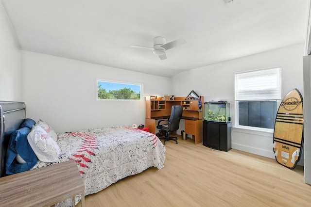 12501 Mixson Dr, Austin, TX 78732 - bedroom with wood finished floors, ceiling fan, and an office area