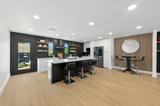 12501 Mixson Dr, Austin, TX 78732 - kitchen featuring open shelves, stainless steel refrigerator with ice dispenser, wall chimney range hood, light wood finished floors, and recessed lighting