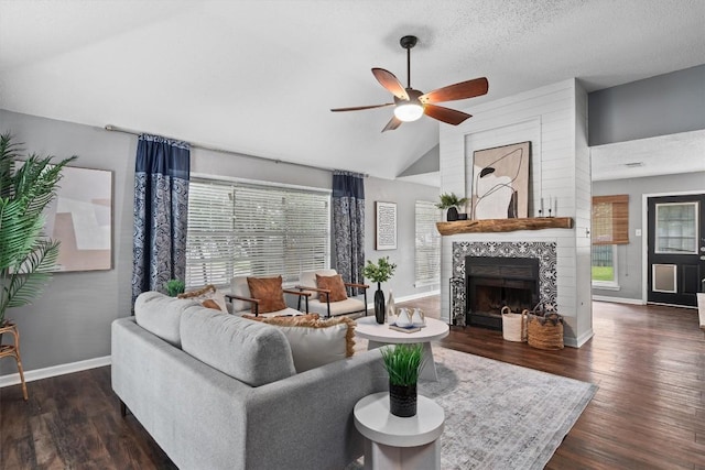 501 Battlecreek Ln, Leander, TX 78641 - living room featuring ceiling fan, lofted ceiling, wood finished floors, a fireplace, and a textured ceiling