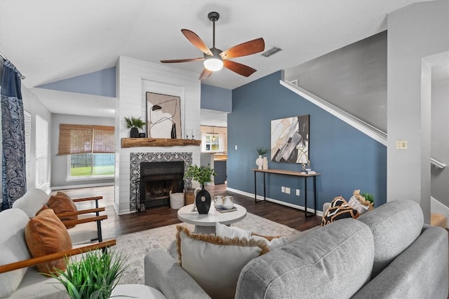 501 Battlecreek Ln, Leander, TX 78641 - living room featuring lofted ceiling, a ceiling fan, wood finished floors, and a tile fireplace