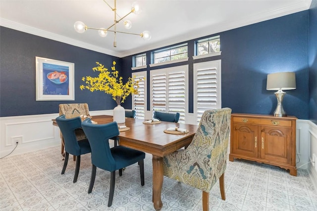 10601 Showboat Cv, Austin, TX 78730 - dining area with a chandelier, ornamental molding, a wainscoted wall, and light tile patterned floors
