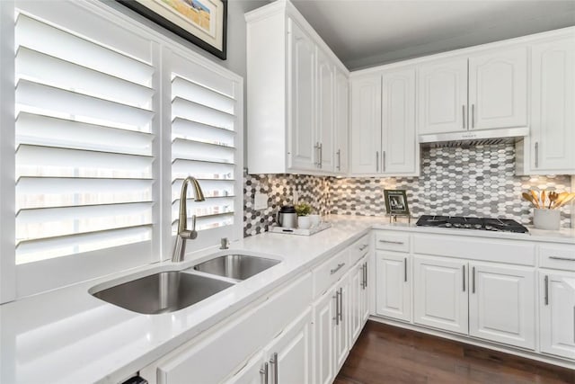 10601 Showboat Cv, Austin, TX 78730 - kitchen with white cabinets, light countertops, backsplash, and gas cooktop