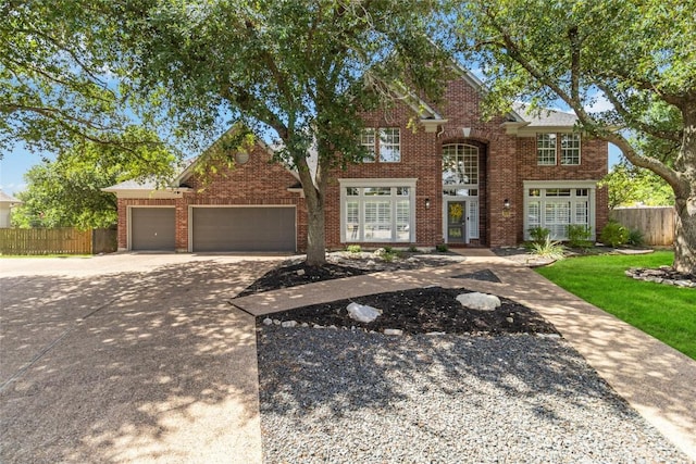 10601 Showboat Cv, Austin, TX 78730 - traditional-style house with concrete driveway, a garage, and brick siding
