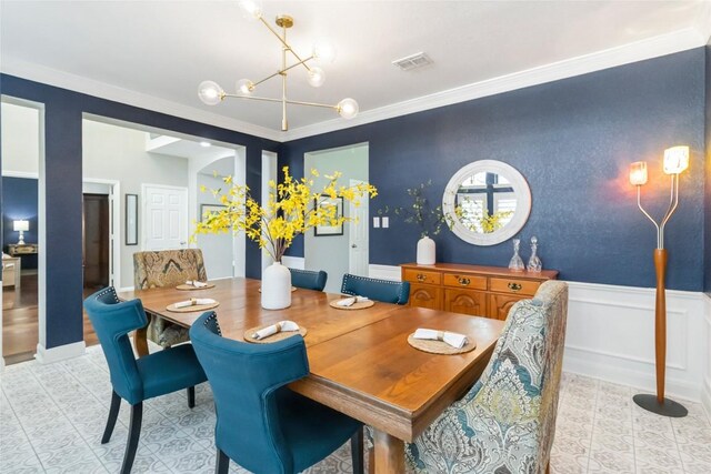 10601 Showboat Cv, Austin, TX 78730 - dining space featuring a chandelier, crown molding, and a wainscoted wall
