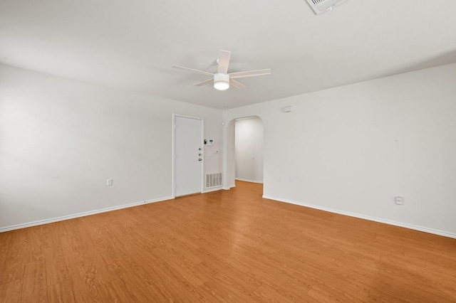 402 Colonial Park Blvd, Austin, TX 78745 - spare room featuring arched walkways, ceiling fan, and wood finished floors