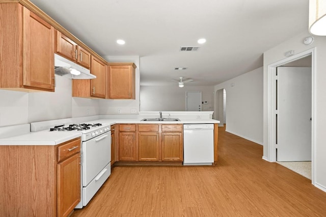 402 Colonial Park Blvd, Austin, TX 78745 - kitchen with white appliances, under cabinet range hood, a peninsula, light wood-style flooring, and ceiling fan