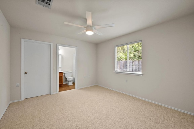 402 Colonial Park Blvd, Austin, TX 78745 - unfurnished bedroom featuring light colored carpet, ensuite bath, and a ceiling fan