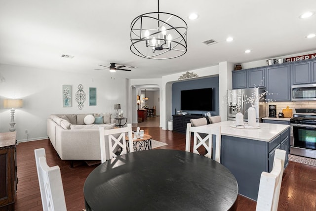 7625 Brecourt Manor Way, Austin, TX 78739 - dining room with a chandelier, arched walkways, dark wood-type flooring, ceiling fan, and recessed lighting