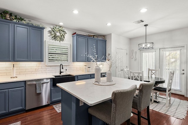 7625 Brecourt Manor Way, Austin, TX 78739 - kitchen featuring dishwasher, blue cabinets, backsplash, dark wood finished floors, and recessed lighting