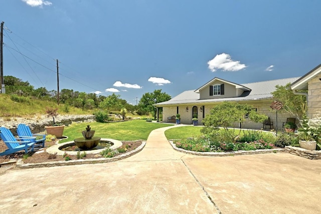 1010 Westland Ridge Rd, Dripping Springs, TX 78620 - view of front of property with a front lawn and a metal roof