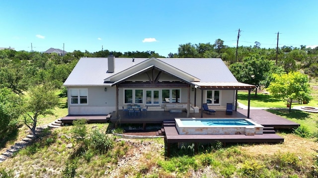 1010 Westland Ridge Rd, Dripping Springs, TX 78620 - back of house featuring a wooden deck, outdoor lounge area, a metal roof, and a chimney