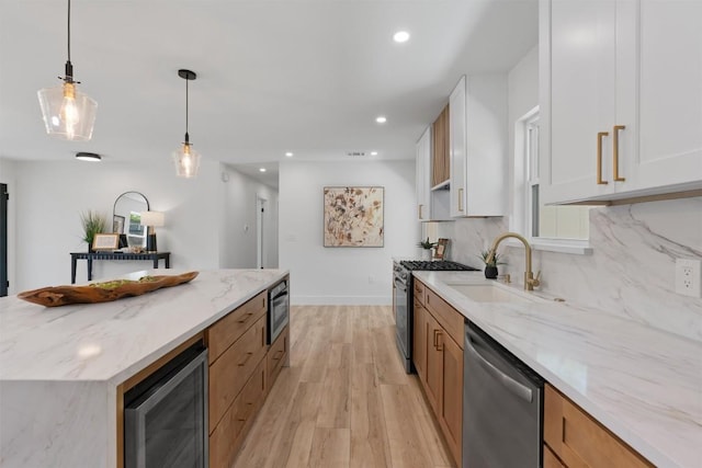 5604 Overbrook Dr, Austin, TX 78723 - kitchen featuring appliances with stainless steel finishes, beverage cooler, light wood-type flooring, light stone counters, and white cabinets